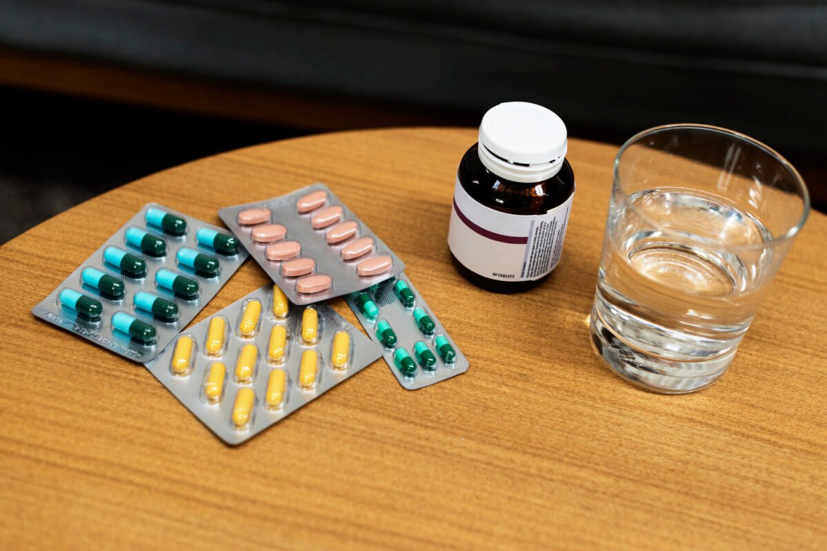 image showing tablets , water on a table
