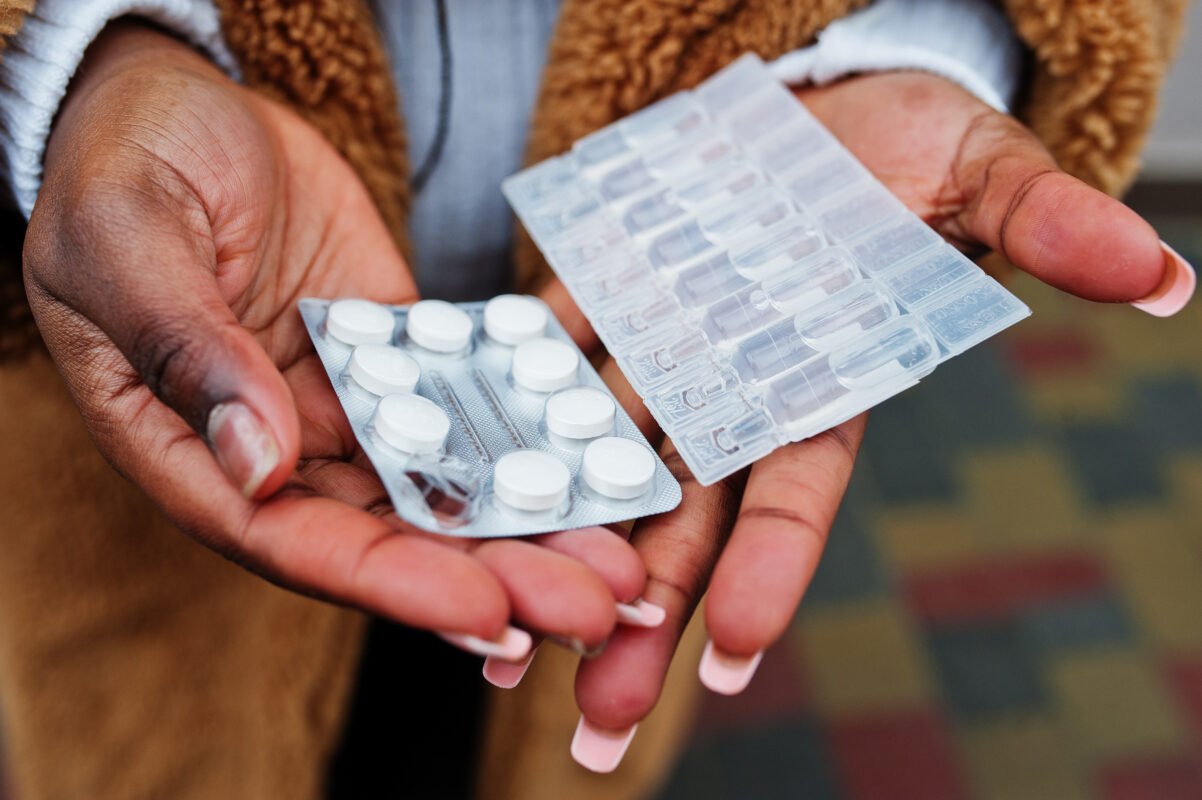 a wooman holding tabs of depresant